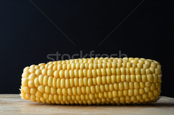 Sweetcorn Cob on Wooden Chopping Board against Black Stock photo © frannyanne