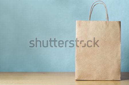 Blank Brown Carrier Bag with Handles on Light Wood Veneer Table  Stock photo © frannyanne