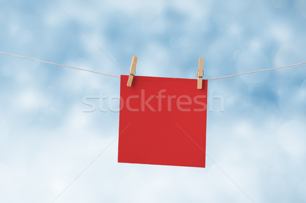 Red Christmas Note Paper Pegged to Clothes Line against Snowy Sk Stock photo © frannyanne