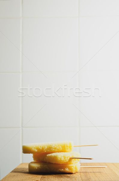 Three Yellow Ice Lollies Stacked on Wooden Kitchen Table Stock photo © frannyanne