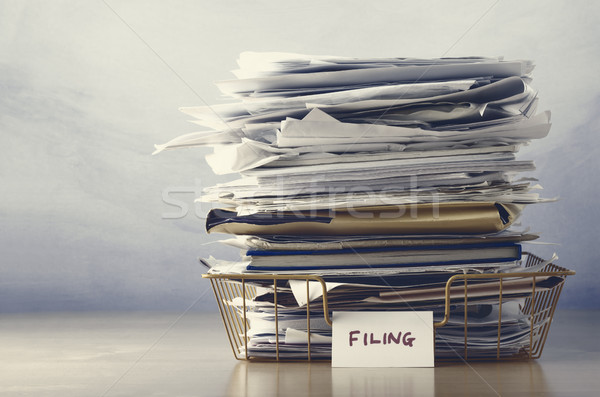Filing Tray Piled High with Documents in Drab Hues Stock photo © frannyanne