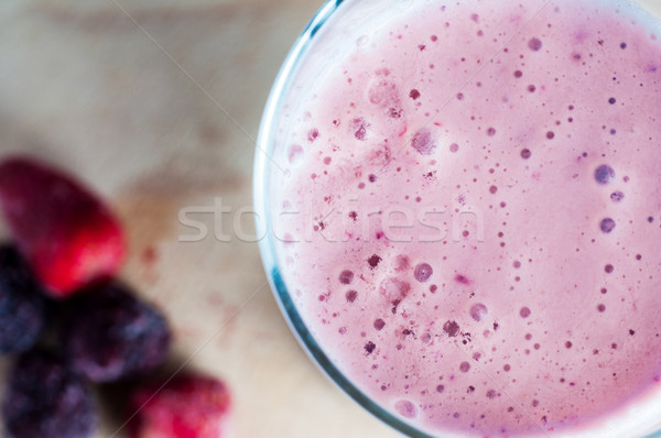 Overhead Close Up of Pink Berry Smoothie with Frozen Fruits on W Stock photo © frannyanne