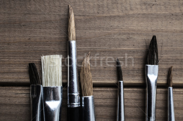 Artist Paintbrushes Overhead on Wood Planks Stock photo © frannyanne