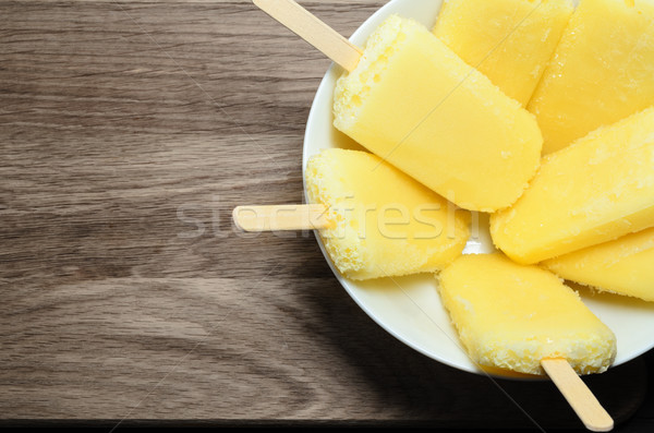 Yellow Pineapple Ice Lollies on Wood from Above Stock photo © frannyanne