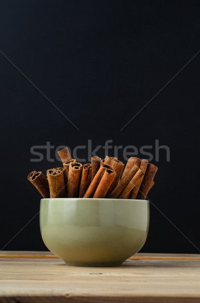 Cinnamon Sticks in Green Bowl with Chalkboard Background Stock photo © frannyanne