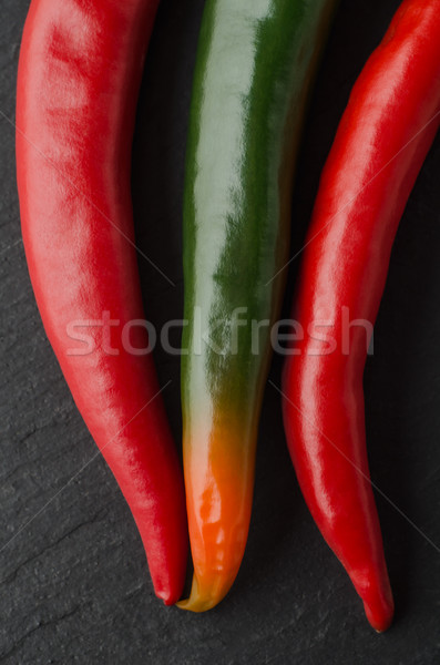 Overhead of Mixed Chilli Peppers on Black Slate Stock photo © frannyanne