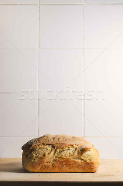 Whole Loaf of Crusty Bread with White Tiled Background Stock photo © frannyanne