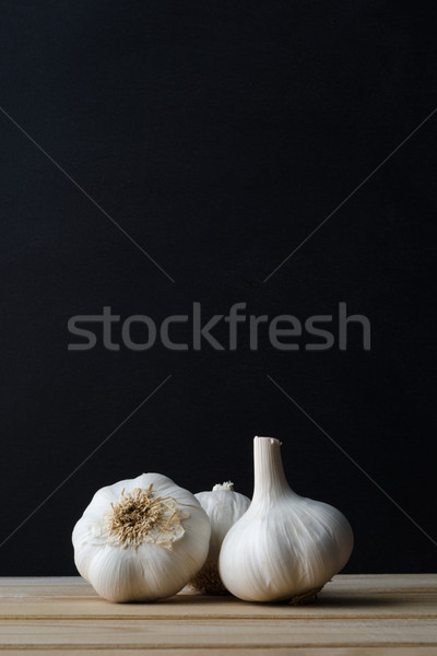 Garlic Bulbs  on Wood Plank Table with Black Background Stock photo © frannyanne