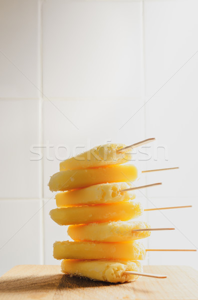 Tall Stack of Yellow Ice Lollies on White Tiled Background Stock photo © frannyanne