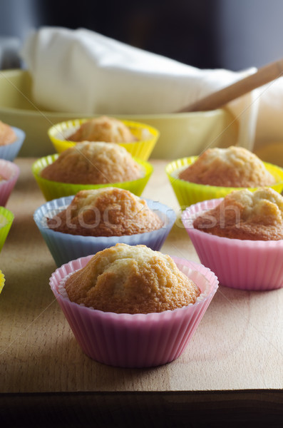 Freshly Baked Cupcakes on Wooden Board in Sunlit Kitchen Stock photo © frannyanne