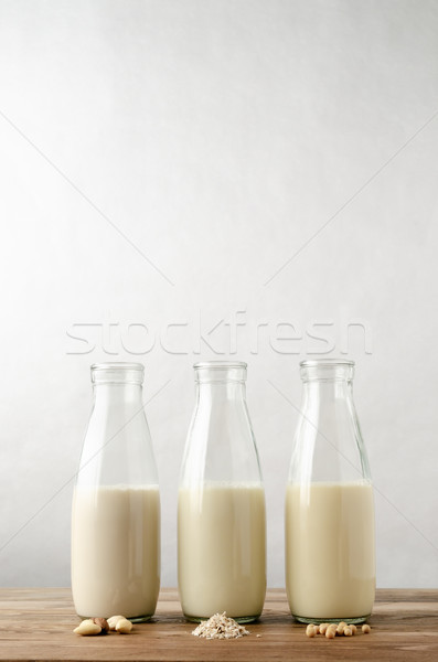 Non Dairy Milk Drinks in Glass Bottles on Wood Stock photo © frannyanne