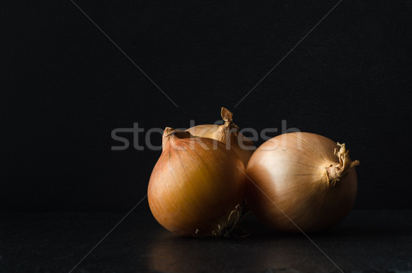 Group of Three Onions on Black  Slate Stock photo © frannyanne