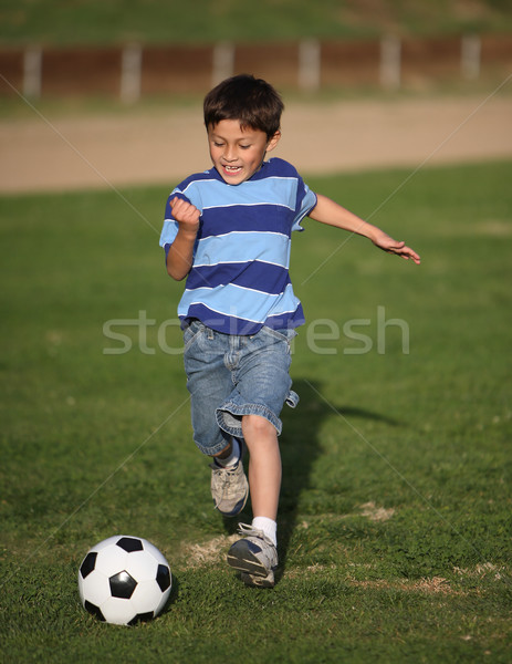 Latino boy playing with soccer ball Stock photo © Freshdmedia