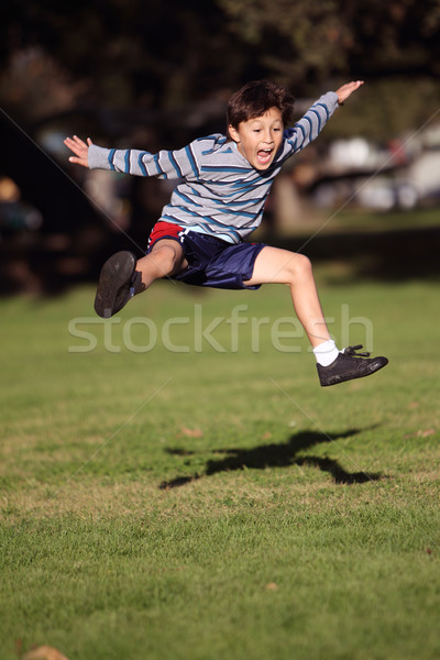 Stock photo: Happy boy jumping in the park