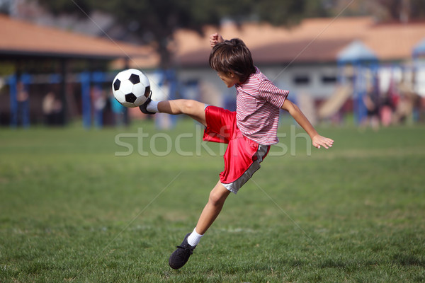 [[stock_photo]]: Garçon · jouer · football · parc · authentique · action