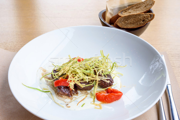 Beef medallions with greens Stock photo © frimufilms