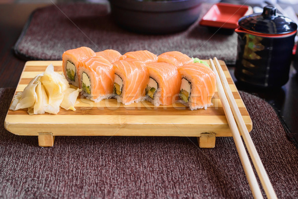 Philadelphia salmon sushi rolls on a wooden plate Stock photo © frimufilms