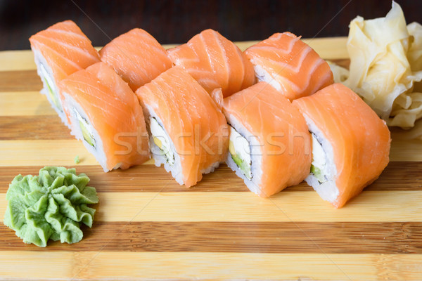 Philadelphia salmon sushi rolls on a wooden plate Stock photo © frimufilms