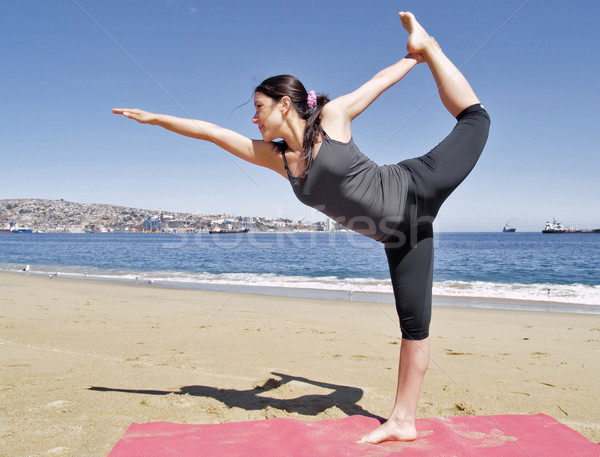 Bikram yoga dandayamana dhanurasana pose at beach Stock photo © fxegs