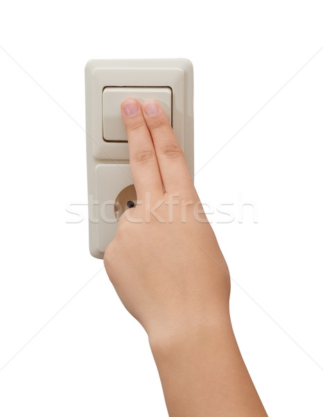 Stock photo: Female hand turns on the light