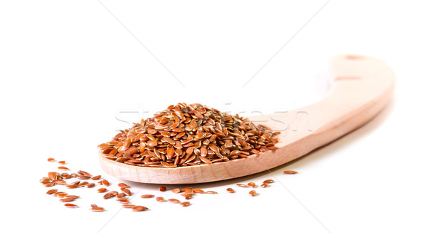 Brown flax seeds in wooden spoon on a white background Stock photo © g215