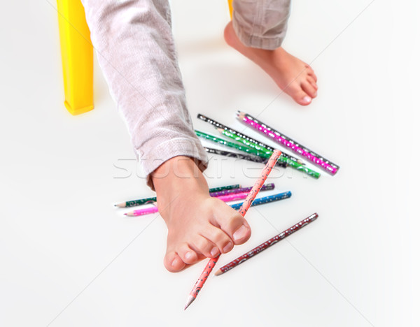 Stock photo: Child's feet  performing gymnastic with pencils