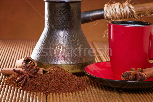 Coffee in a red cup with cinnamon and anise stars. Stock photo © g215