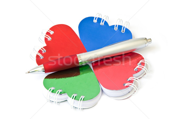 Four heart-shaped notepad and pen. Stock photo © g215