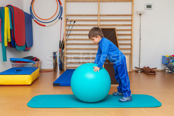 Child is therapeutic exercises in the gym Stock photo © g215