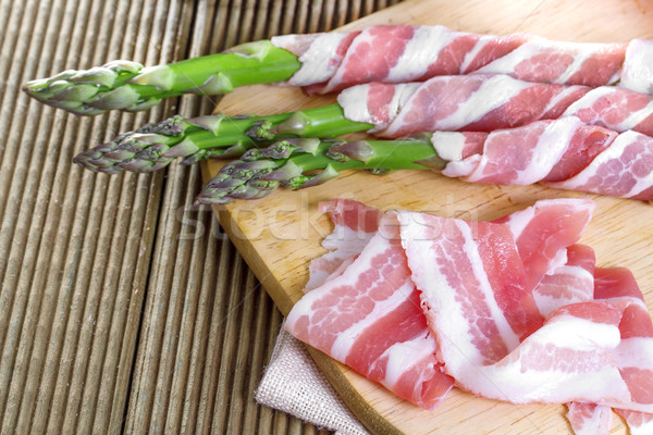 Stock photo: Bacon and asparagus on a wooden background