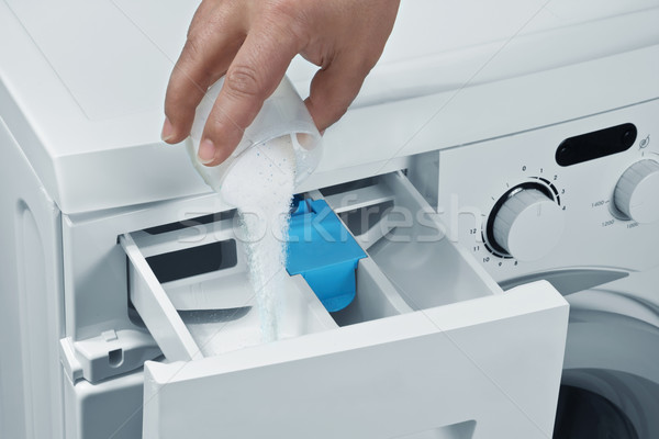 Man pours detergent into the washing machine  Stock photo © g215