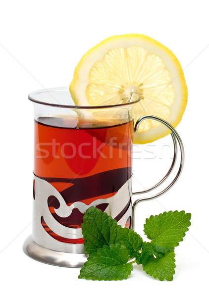 Tea in a glass holder and a sprig of lemon balm Stock photo © g215