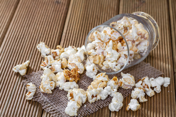 Popcorn in a glass on a wooden background Stock photo © g215