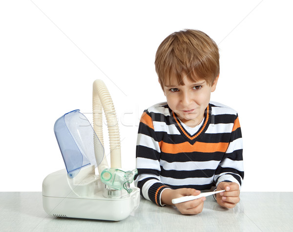 The boy looks at the thermometer. Isolate on white background Stock photo © g215