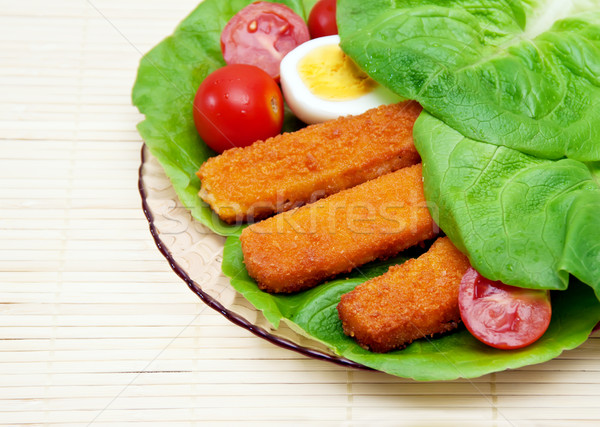 Fish sticks with egg salad on a platter. Stock photo © g215