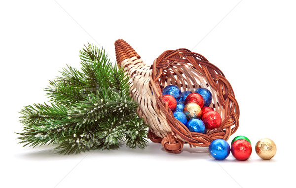 Cornucopia of chocolate balls and pine-branch. Stock photo © g215