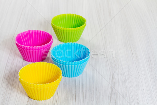 Colorful silicone baking cups on wooden background. Stock photo © g215