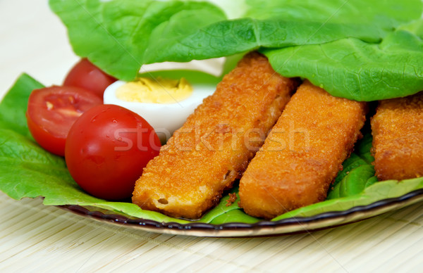 Fish sticks with egg salad on a platter. Stock photo © g215