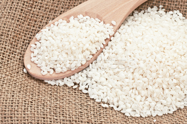 Stock photo: Rice handful on a sacking