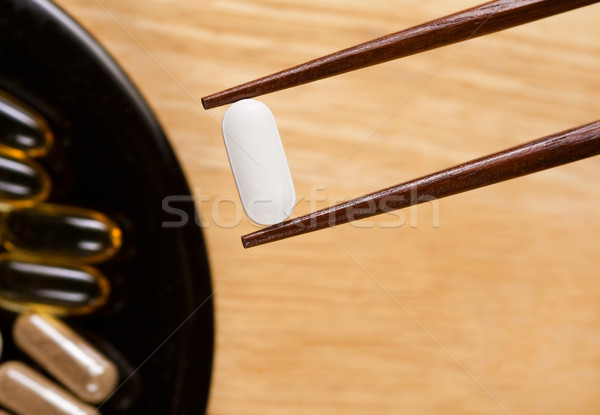 Taking Supplements with Chopsticks. Stock photo © gabes1976