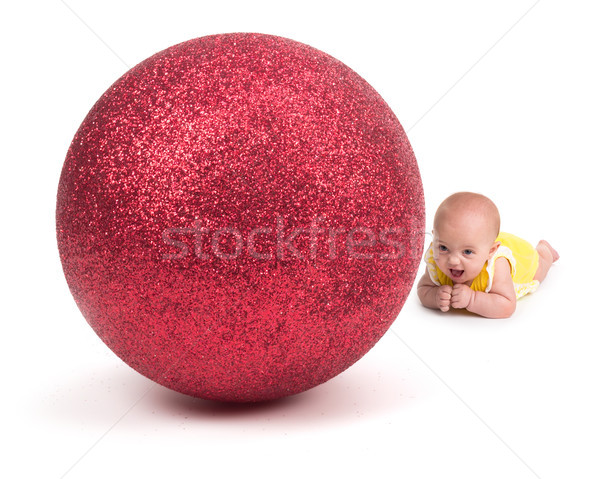 Cute Baby smiling at a Huge Christmas Ornament on white Stock photo © gabes1976
