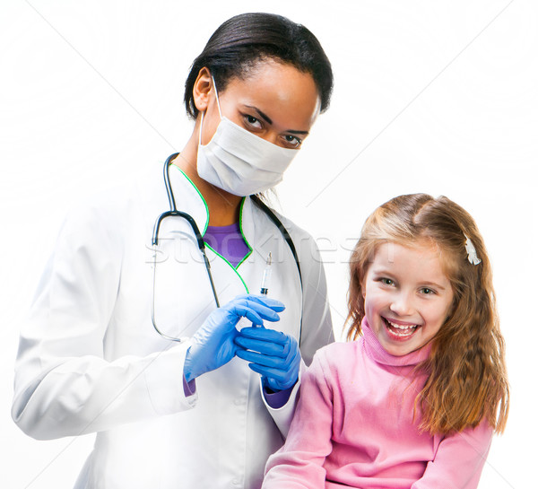 Doctor doing vaccine injection to a child Stock photo © GekaSkr