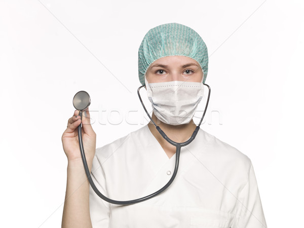 Female nurse with a stethoscope isolated towards white backgroun Stock photo © gemenacom