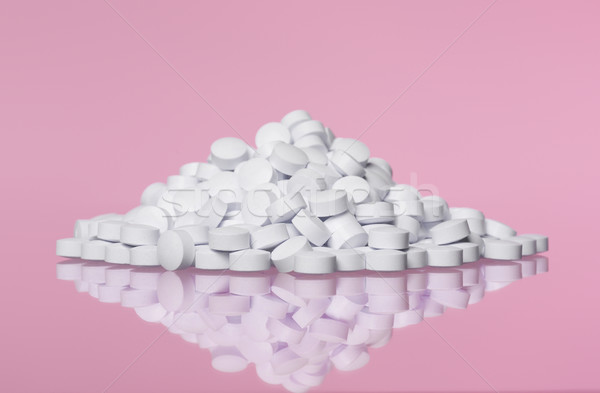 Stack of pills towards pink background Stock photo © gemenacom