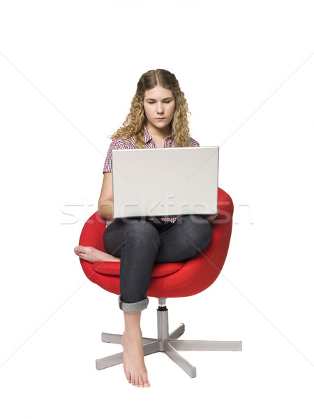 Girl in a armchair with a computer Stock photo © gemenacom