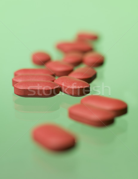 Red pills toward green background Stock photo © gemenacom