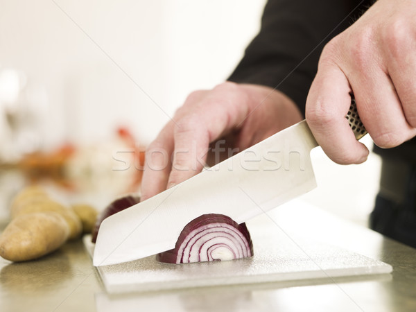 Cutting onion with a knife Stock photo © gemenacom