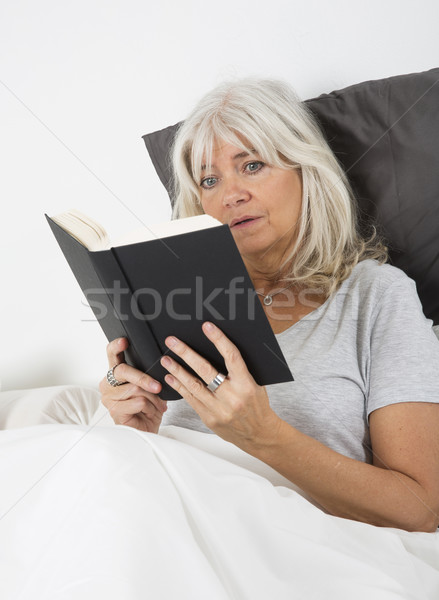 Reading a nail-biting book Stock photo © gemenacom