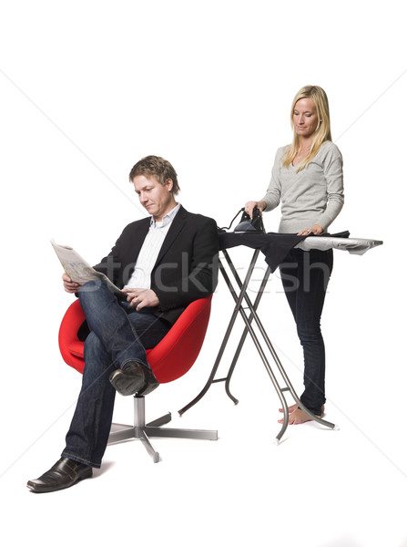 Woman ironing and the man reading a paper Stock photo © gemenacom