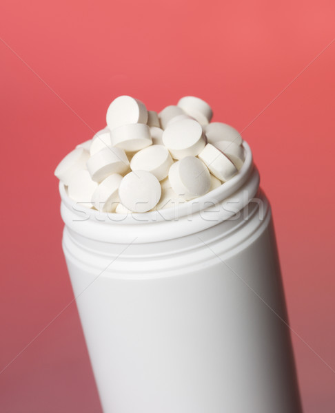 Can with pills towards red background Stock photo © gemenacom